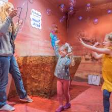 Family enjoying bubble cave in Customs House Museum, Clarksville, TN.