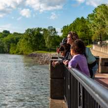 family at an overlook along the Riverwalk