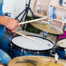 A close up of a man drumming.