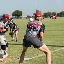 a few men on a baseball field hitting the ball