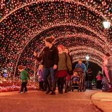 family walking through a light tunnel