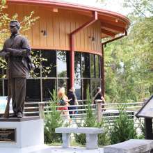 statue of an African American soldier beside a visitor center