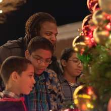 family looking at a Christmas Tree