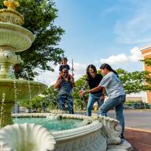 family by a fountain in a historic downtown