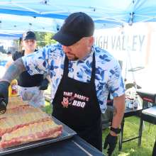 A man seasoning ribs.
