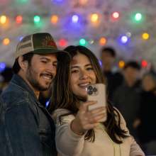 Couple taking selfie in front of Tumbleweed Tree in Chandler, AZ