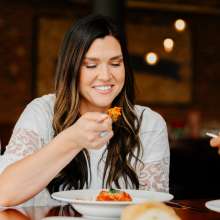 lady eating Italian food and wine