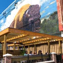 Friends dining on the outdoor patio deck at Nawa on The Landing