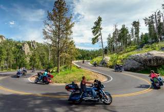 motorcycles taking the turns of needles highway in custer state park