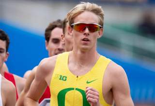 Simeon Birnbaum runs a race wearing his bright yellow University of Oregon uniform, complete with a large green O.