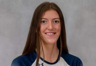 A team headshot of Lexi Glendenning, wearing her white and blue volleyball uniform with "Rockers" and number 5 in blue across her chest.