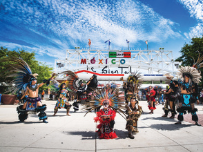 traditional Mexican dance in front of Mexican Fiesta festival grounds main gate
