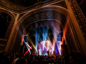 inside view of the Pabst Theater with concert ongoing, bright lights, crowd