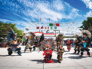 traditional Mexican dance in front of Mexican Fiesta festival grounds main gate
