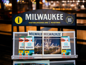 A display of Visit Milwaukee collateral including official visitors guides and maps.