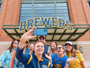 A group of Brewers fans smile in front of American Family Field