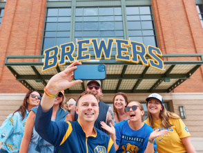 A group of Brewers fans smile in front of American Family Field