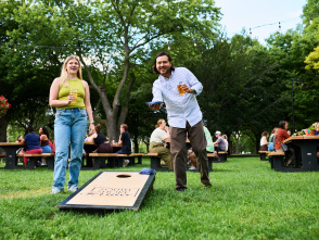 A man and woman playing bags at Juneau Beer Garden