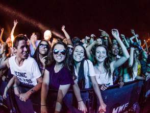 A group of people at the front row of a music performance