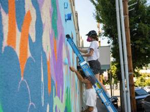Tim and Hannah Eddy painting mural.