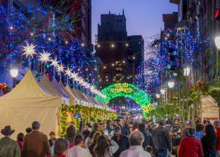 Festive holiday lights above outdoor market
