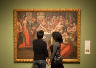 Man and woman looking at painting