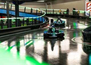 Kids racing on go-kart track.