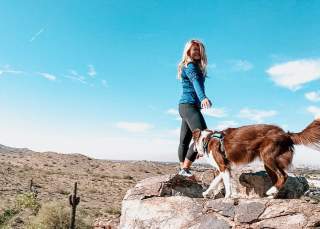 Woman Hiking With Her Dog In Chandler, AZ