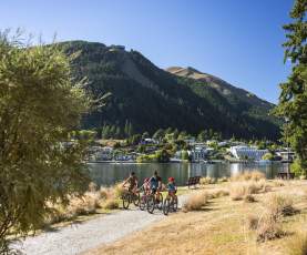 Family Biking Queenstown Gardens with views of lake and mountains