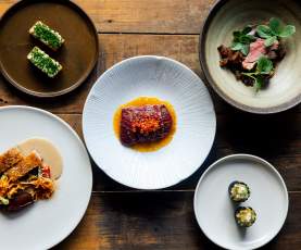 Photo of lots of plates with colourul food