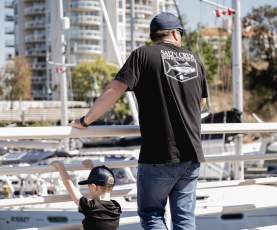 A boy and his dad look over the Nanaimo harbour.