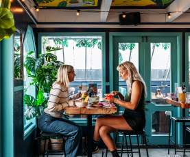 Two women eating at a table in a restaurant