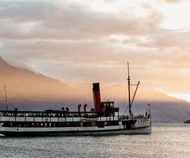 Vintage steamship TSS Earnslaw sailing through Lake Whakatipu at dusk