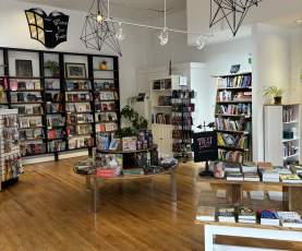Bookstore layout showing books on tables and displays.