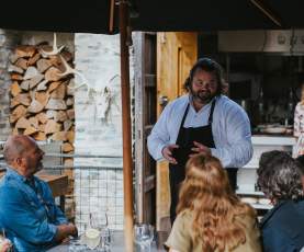 Chef Vaughan Mabee talking with guests, Amisfield
