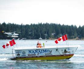 A bathtub boat being raced.
