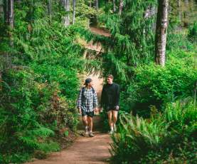 Two men walking on a dirt path to Ammonite Falls
