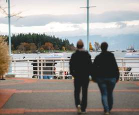 Two people walking on the Nanaimo waterfront.