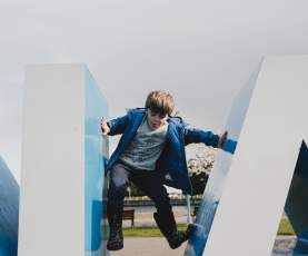 A kid climbing the Nanaimo sign.