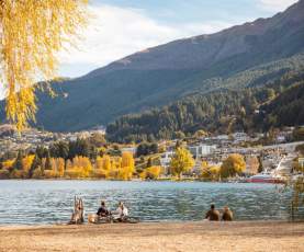 A group of friends enjoying the calm autumn day at the Queenstown lakefront