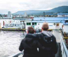 Two people looking over the Nanaimo harbour.