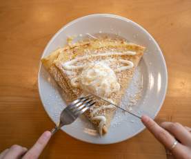 A crepe being cut into.