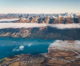 Aerial photo of Glenorchy township with huge mountains in the background