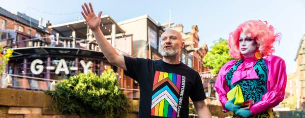 Tour guide on Manchester's Canal Street delivering LGBT tour of the city