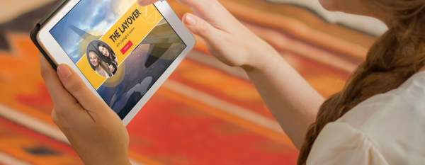 A person looks at the Layover Live on a tablet.