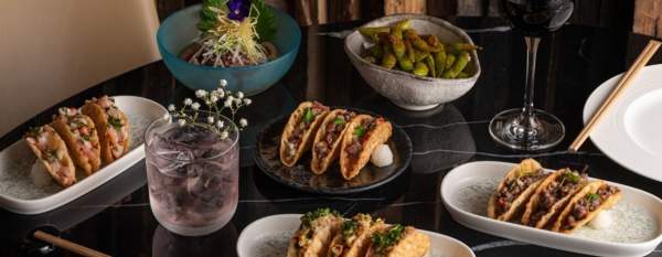 Plates of tacos with drinks on table at restaurant