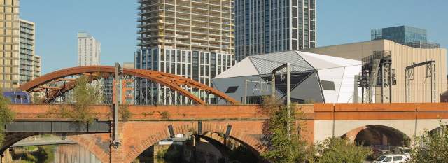 River and bridge in a city with Aviva Studios in the background