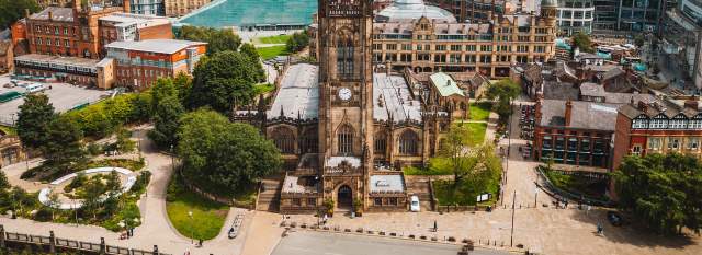 Cathedral in Manchester city centre with cityscape in the background