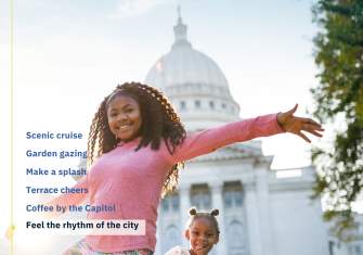 Cover of the 2022 Destination Madison Visitors Guide featuring two young Black girls smiling and dancing in front of the Wisconsin State Capitol building