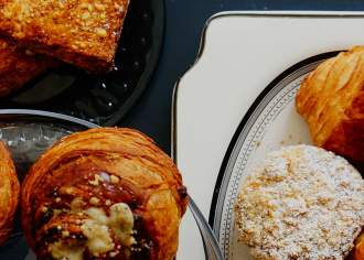 Assorted pastries including croissants and chocolate swirls on plates